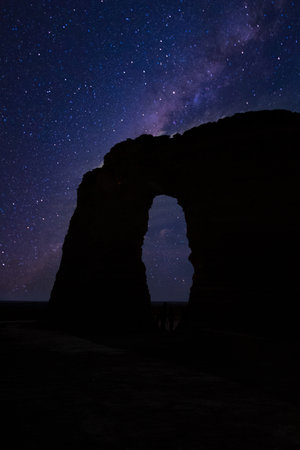 A vertical shot of a milky way galaxy seen from the rocky archの写真素材
