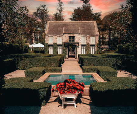 A beautiful landscape of a house with a decorated garden and a poolの写真素材