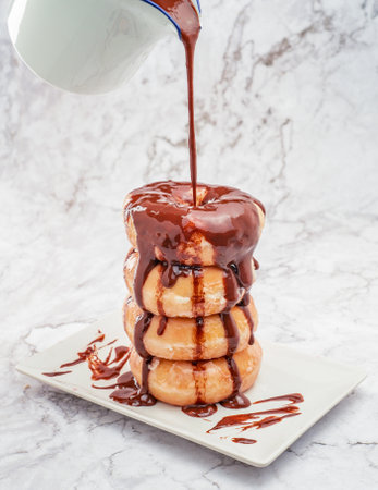 A closeup sho of delicious chocolate donuts on the tableの写真素材