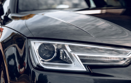 Close-up photo of headlight on dark grey audi a4 car.