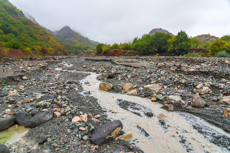 A low angle shot of rainwater flowing through the pebblesの写真素材