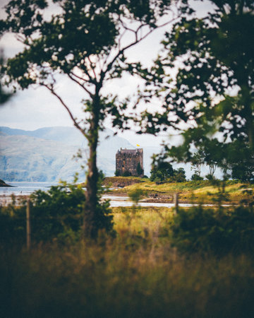 A vertical shot of an isolated castle in Scotland during daylightの写真素材