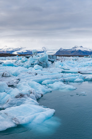 A beautiful landscape with floating icebergs in Jokulsarlon glacier lagoon at sunset