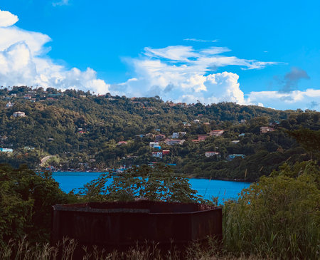A blue lake in a green mountainous area on a sunny morningの写真素材