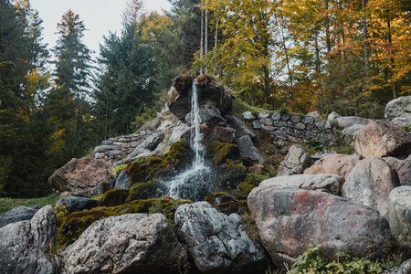 A small waterfall in a rocky area in a forestの写真素材