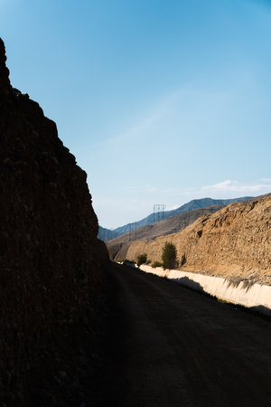 A road in a mountainous area on a sunny morningの写真素材