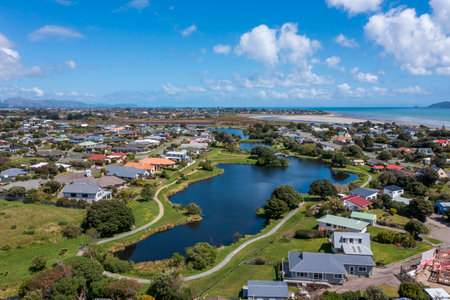 Waimanu Lagoon at Waikanae Beach on the Kapiti coast of New Zealand. It is a wild life refuge surrounded by houses of the beach villaの写真素材