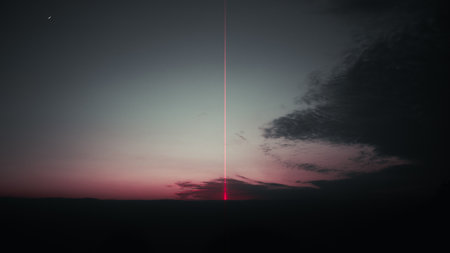 A beautiful view of the cloudy night sky with a laser lightの写真素材