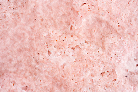 A closeup of the pink salt lake sand under the sunlight - perfect for wallpapersの写真素材