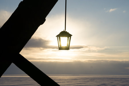 A scenic view of a lantern hanging on a sunny sky backgroundの写真素材
