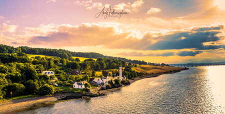A beautiful scenery of a great sunset over the Lighthouse in Tay port, Scotlandの写真素材