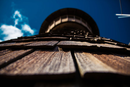A low angle shot of a wooden tower and a blue skyの写真素材