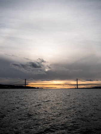 A vertical shot of a metallic bridge on a sea and sky background.の写真素材
