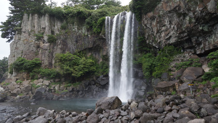 A beautiful shot of a waterfall on rocky hillsの写真素材
