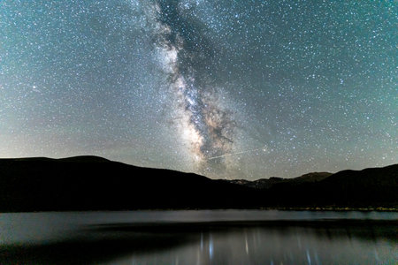 A beautiful starry night and a lake in a forest