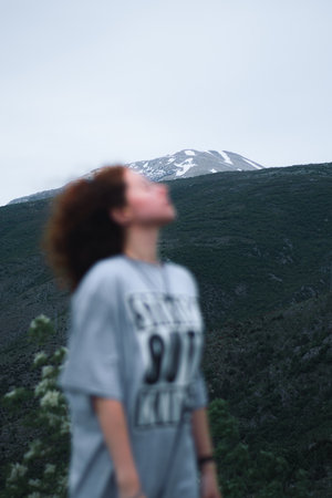 A vertical shot of a blurred female posing in a forest during the dayの写真素材
