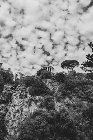 A grayscale of old old architecture on top of a hill on a cloudy dayの写真素材