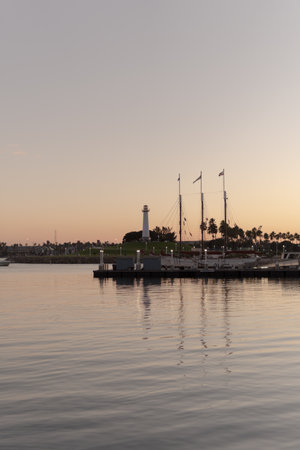 A vertical shot of a harbor with boats and ships at the sunsetの写真素材