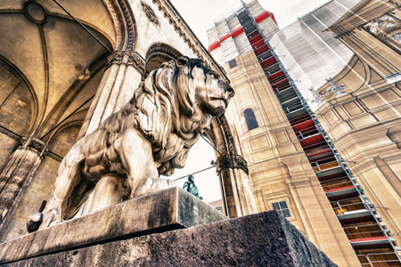 A low angle shot of the Famous lion statue in Odeonplatz, Munich, Germanyの写真素材