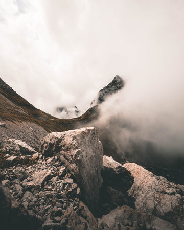 A mesmerizing view of beautiful Swiss mountains under the clouds on a gloomy dayの写真素材