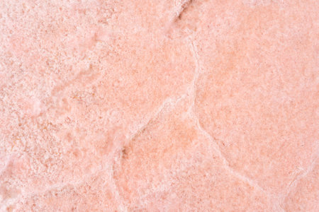A closeup of the pink salt lake sand under the sunlight - perfect for wallpapersの写真素材