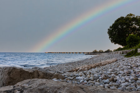 A colorful rainbow across the beachの写真素材