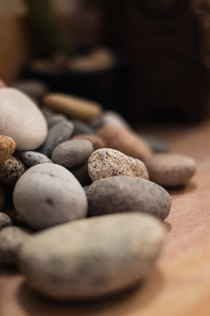 A vertical shot of a stack of smooth sea stones