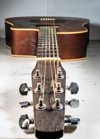 An old dusty acoustic guitarの写真素材
