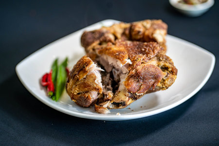 A crispy deep-fried pork hind on a white plateの写真素材