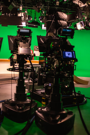 A vertical shot of a television studio with professional cameras and lightsの写真素材