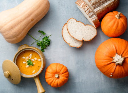 A top view of pumpkins and squashes, with pumpkin soup and breadの写真素材