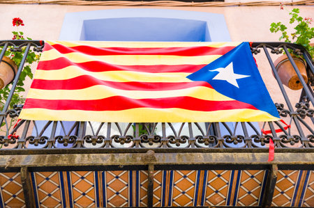 A low angle shot from under a balcony in Estelada, the Catalan independentist flag, Girona, Spainの写真素材
