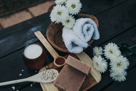 A flat lay shot of towels, soaps, and flowers on the table