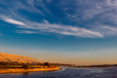A scenic shot of the mesmerizing River Nile and the beach under the cloudy sky in Egyptの写真素材