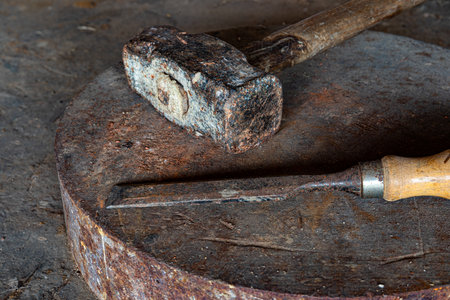 A selective focus shot of antique work tools - sledgehammer and knif
