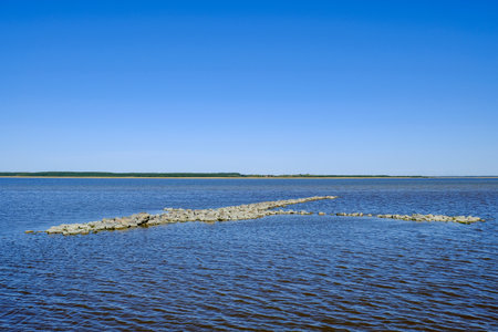 A scenic view of a blue baltic sea with rocky formation and sky in Haapsalu, Estoniaの写真素材