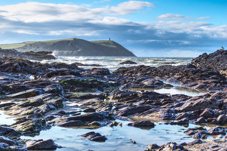 A mesmerizing view of a beautiful rocky seashore under a cloudy skyの写真素材