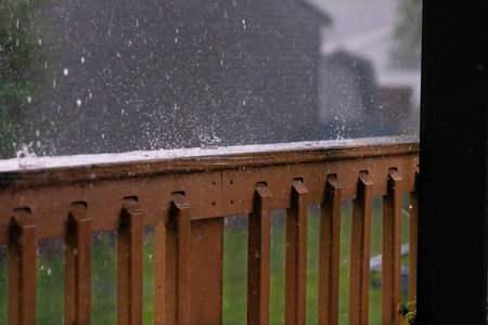 A beautiful shot of snowflakes falling on a wooden fence