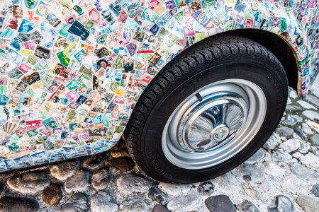 A historic car covered with postage stampsの写真素材