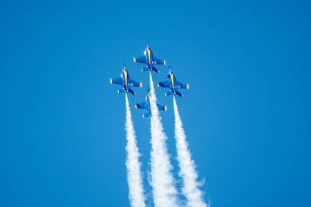 A group of flying aircraft against a blue sky during an airshowの写真素材