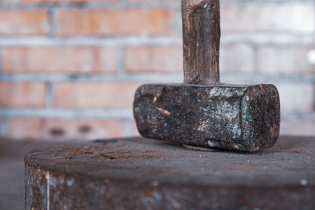 A selective focus shot of an antique work tool - sledgehammer