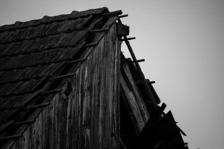 A grayscale shot of the wooden roof of an old barn.の写真素材