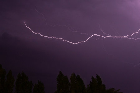 The beautiful violet lightning in the night sky.