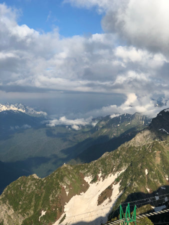 An aerial view of vast mountain landscape under a cloudy sky