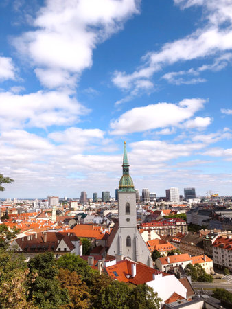The St. Martin's Cathedral and Bratislava cityscape in Slovakia against a cloudy blue skyの写真素材