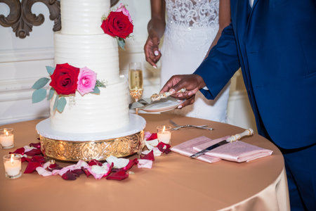 A Closeup of a bride and groom cutting a wedding cakeの写真素材
