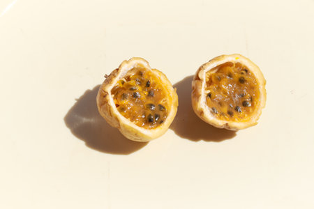 A closeup shot of yellow passion fruit cut in halfの写真素材