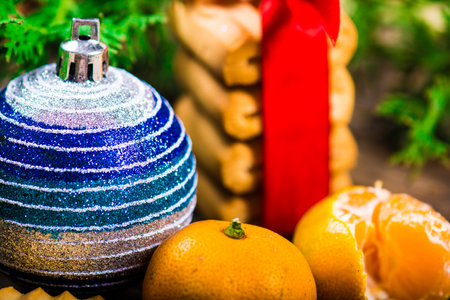A table with cookies, mandarins and Christmas tree ballsの写真素材
