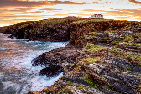 A mesmerizing view of a beautiful rocky seashore at scenic sunsetの写真素材