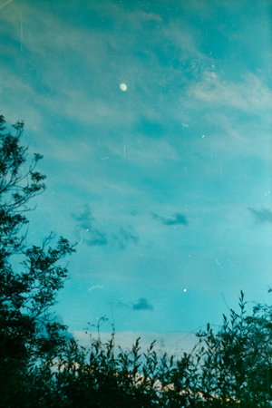 The beautiful shot of an evening blue sky and a moon.の写真素材